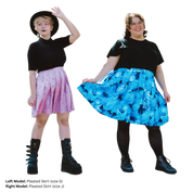 Two models wearing different versions of the Classic Pleated Skirt. The model on the left (size G) has a pink pleated skirt with moons and stars on it. The model on the right (size J) is wearing a bright blue pleated skirt with dragons on it.