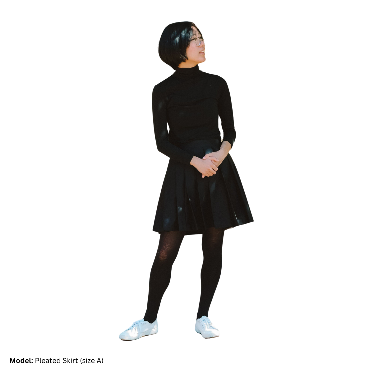 A female model (size A) wearing a solid black Pleated Skirt.