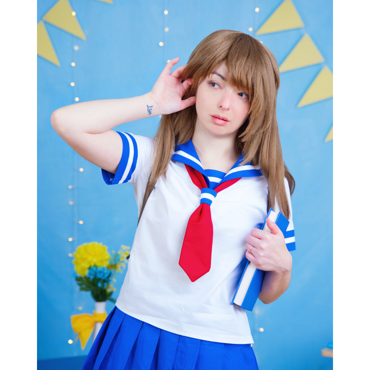 Female model (size C) posing in a white and blue short-sleeve Sailor Blouse with red tied scarf.