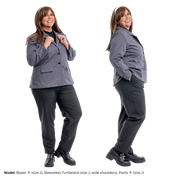 Plus size model (size J) in a gray Blazer at two different angles. On the left, she is facing front and holding the collar. On the right, she's profiled to the camera, showing the sleeves. The blazer is paired with pants.