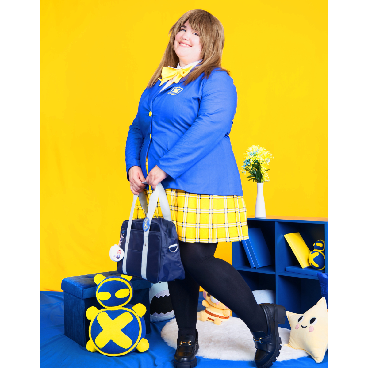 Female plus size model posing in a blue Blazer and yellow pleated skirt.